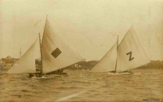 Postcard featuring a photograph of two skiffs sailing