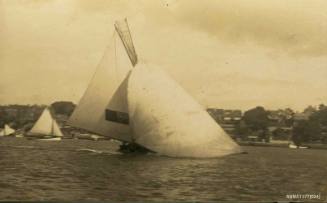 Postcard featuring a photograph of a skiff sailing