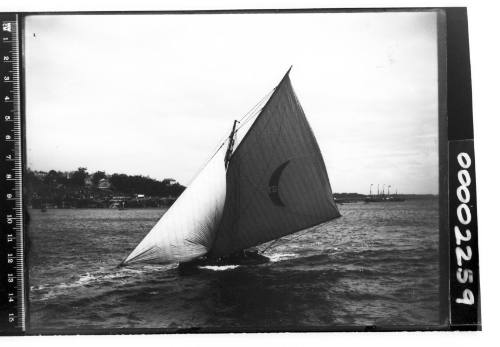 Yacht on Sydney Harbour with a crescent moon emblem and the number '47' displayed on the mainsail, possibly DEFIANCE or KERIKI