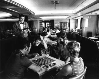 Photograph depicting a group of people playing checkers
