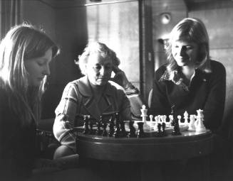 Photograph depicting two women playing chess