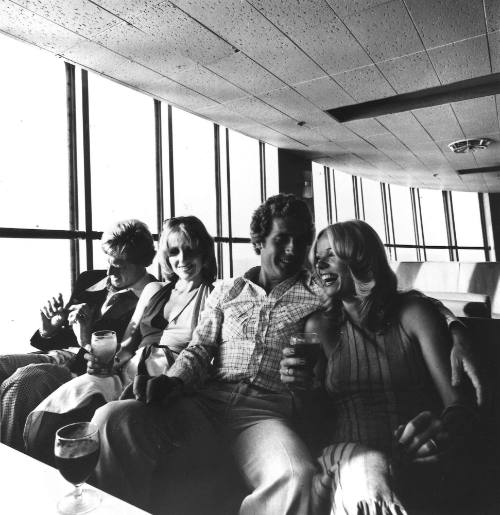 Photograph depicting two couples having a drink