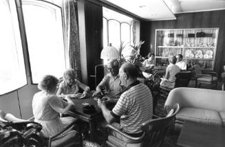 Photograph depicting a group of people playing cards
