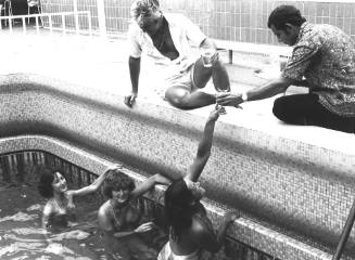 Photograph depicting three women in the ship's pool