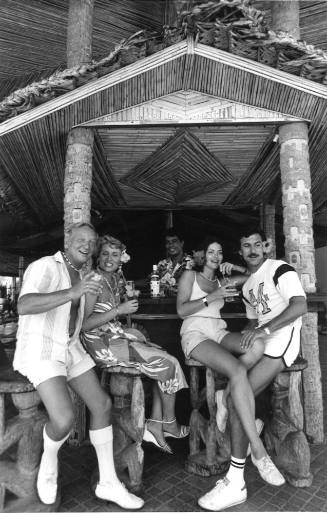 Photograph depicting two couples at a bar