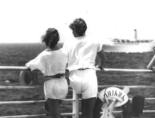 Photograph depicting a couple standing by ORIANA's rail