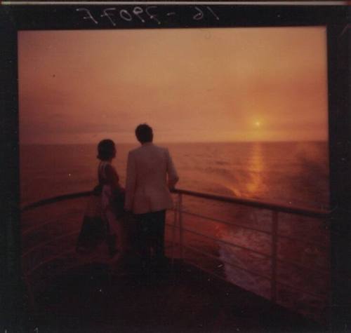 Negative depicting a couple standing by the ship's rail