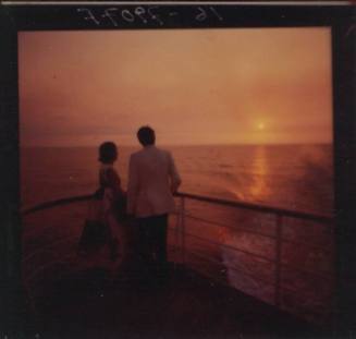 Negative depicting a couple standing by the ship's rail