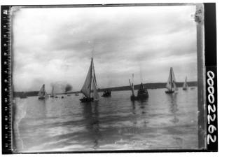 Open boats racing in calm conditions on Sydney Harbour, New South Wales