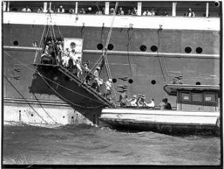 Passengers descending an accommodation ladder into a launch, RMS AORANGI