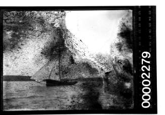 Glass plate negative image of a yacht on a harbour