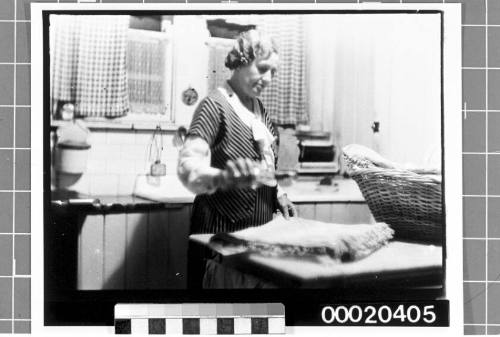 Unidentified woman folding laundry