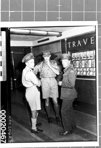 Military personnel standing in the corridor of RMS QUEEN MARY