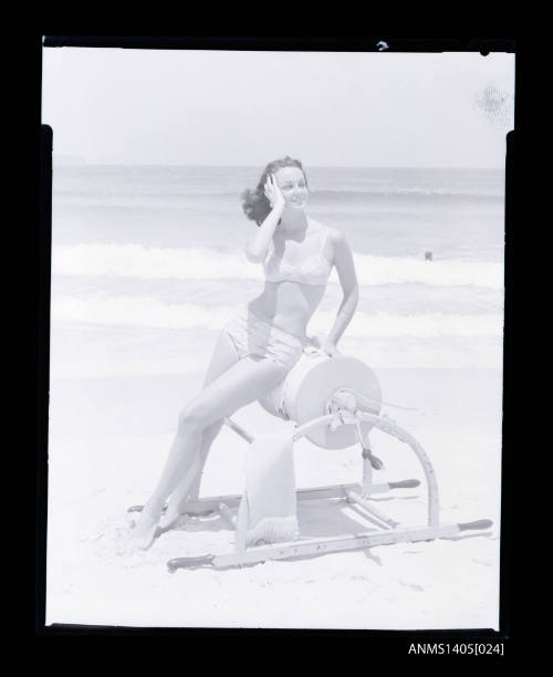 Negative depicting a woman sitting on a surf reel