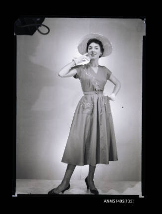 Negative depicting a woman  modelling a summer dress