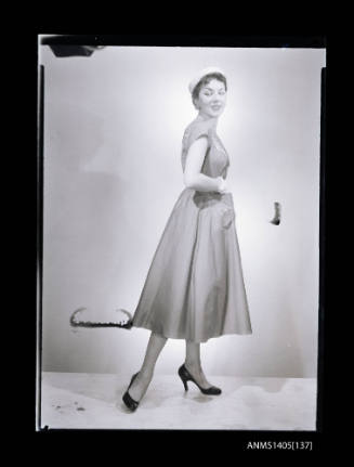 Negative depicting a woman  modelling a summer dress