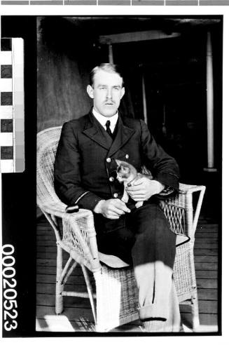 Portrait of an unidentified merchant marine officer, possibly of the British India Steam Navigation Company Ltd, with a kitten
