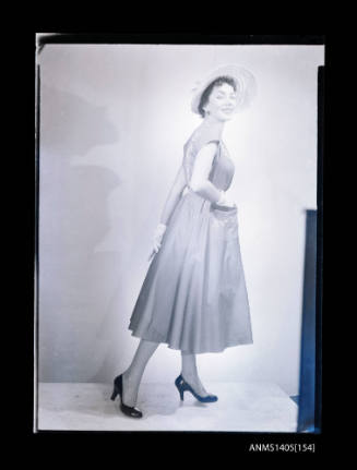 Negative depicting a woman  modelling a summer dress