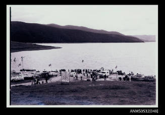 Cars, ambulance and people along edge of Blowering Dam