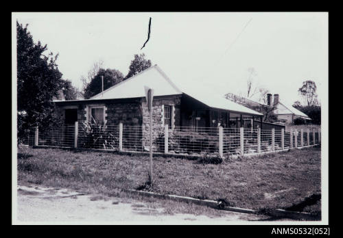 Single storey stone building with sloping corrugated iron roof