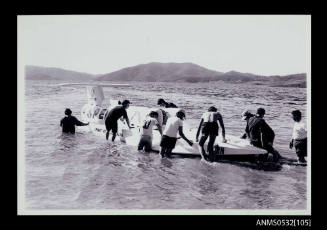 Men gathered around SPIRIT OF AUSTRALIA on Blowering Dam