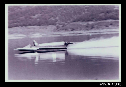 Slightly blurred water view Blowering Dam with speed boat METEOR under power