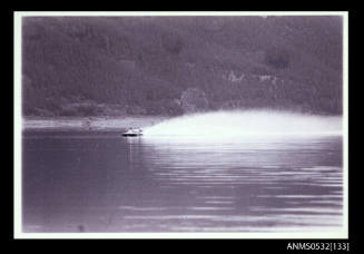 Water view Blowering Dam with speed boat under power SPIRIT OF AUSTRALIA and driver visible in the cockpit