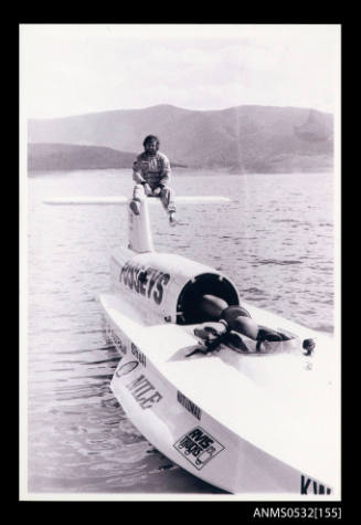 Ken Warby sitting on the tail plane of SPIRIT OF AUSTRALIA