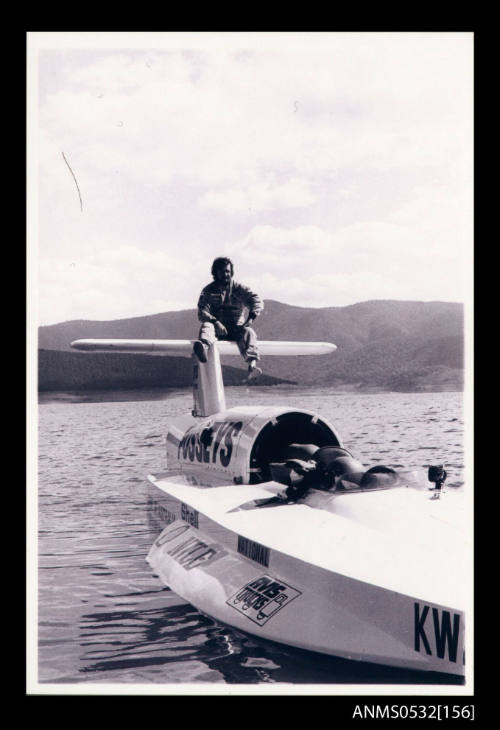 Ken Warby sitting on the tail plane of SPIRIT OF AUSTRALIA