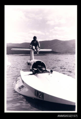 Ken Warby sitting on the tail plane of SPIRIT OF AUSTRALIA