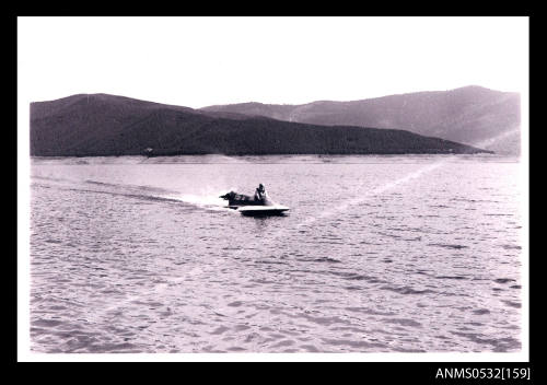 Blowering Dam with distant view of speed boat under power