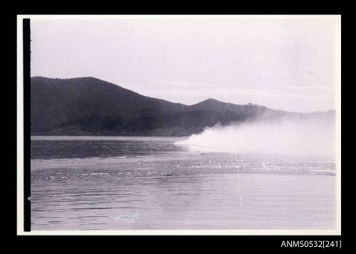 Blowering Dam with white spray from the tail fin of hydroplane SPIRIT OF AUSTRALIA