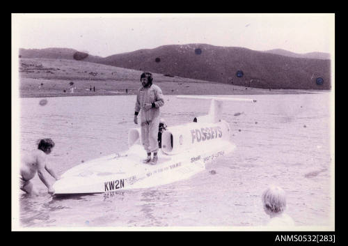 Ken Warby standing on SPIRIT OF AUSTRALIA at Blowering Dam