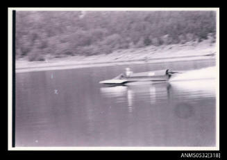 Speed boat under power on Blowering Dam