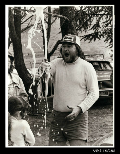 Ken Warby celebrating with a bottle of champagne