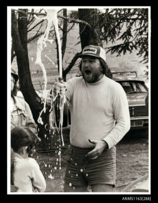 Ken Warby celebrating with a bottle of champagne