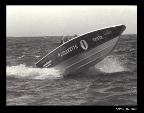 Ocean racing power boat CIGARETTE VH93N with driver and co-driver at high speed