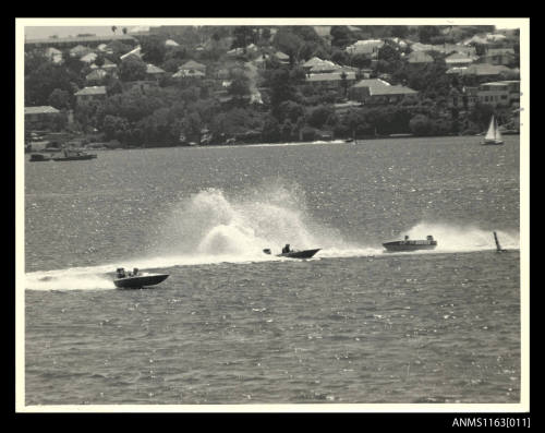 Two racing power boats with outboard engines unidentified completing a 180 degree turn