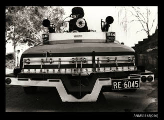 The rear view of racing power boat on its road trailer registration on trailer