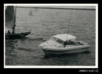 Half cabin power boat and twin hulled outrigger canoe