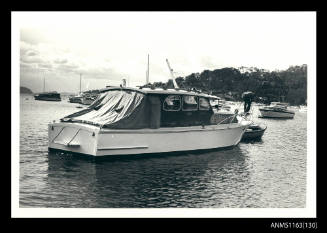 Cabin cruiser at mooring buoy