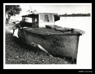 Commercial river launch MAC moored alongside river bank