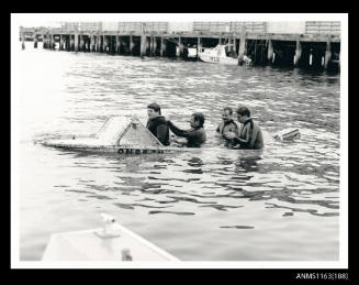 The view of open 4-seater power boat with outboard engine and windscreen