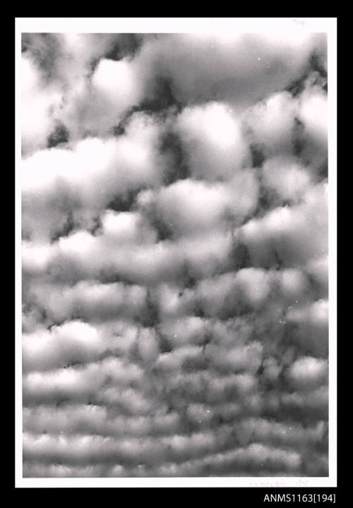 The mass of thin fleecy clouds with uniform pattern with parallel lines across the image