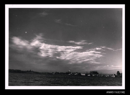 The thin stratus clouds across the middle third of image with clear sky above