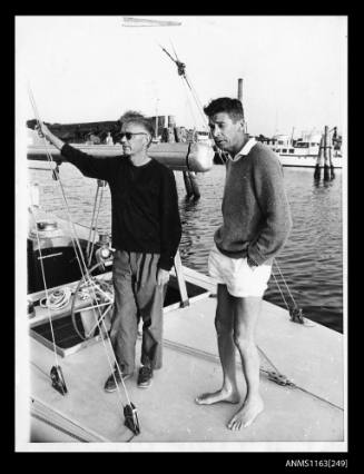 Two men standing on deck of sailing boat CONSTELLATION