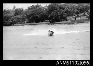 Black and white negative number 15 depicting power boat with outboard engine under way at speed