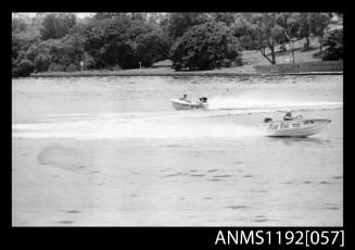 Black and white negative number 16 depicting two power boats with outboard engines under way at speed, MISS KRIS TOO