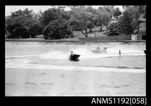 Black and white negative number 17 depicting two power boats with outboard engines under way