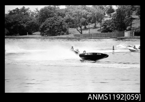 Black and white negative number 18 depicting power boat HOT ROD III Jk15n with outboard engine under way